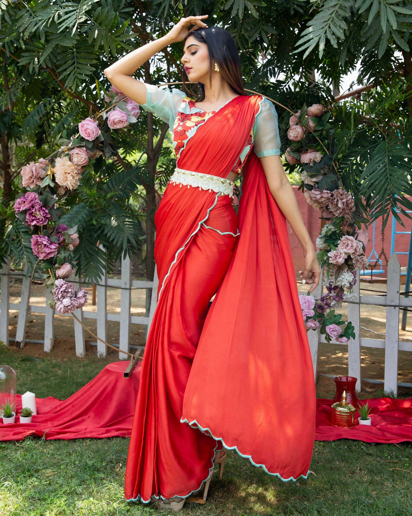 Red pre-draped saree with a printed blouse and embellished belt - Nishi Madaan Label