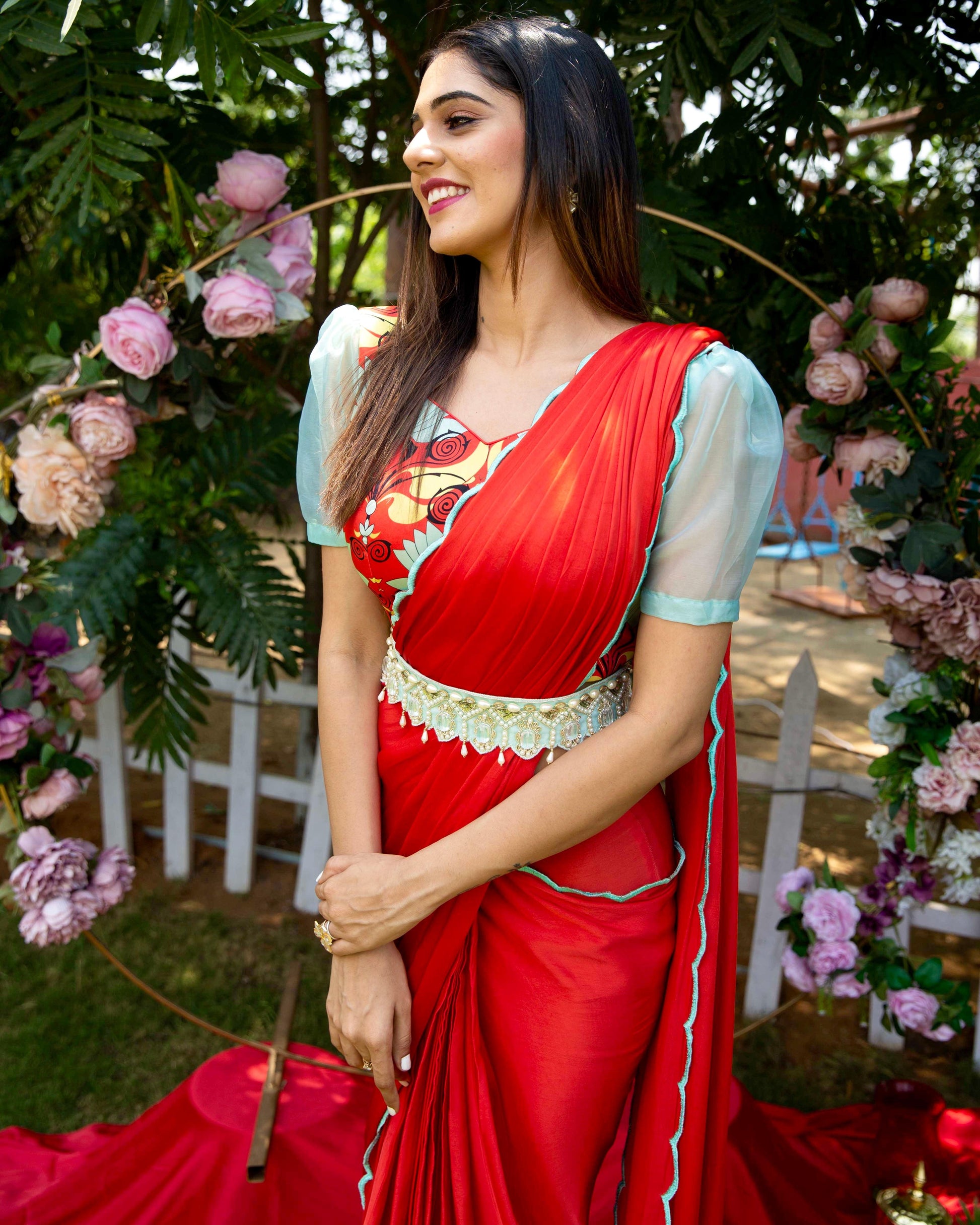 Red pre-draped saree with a printed blouse and embellished belt - Nishi Madaan Label