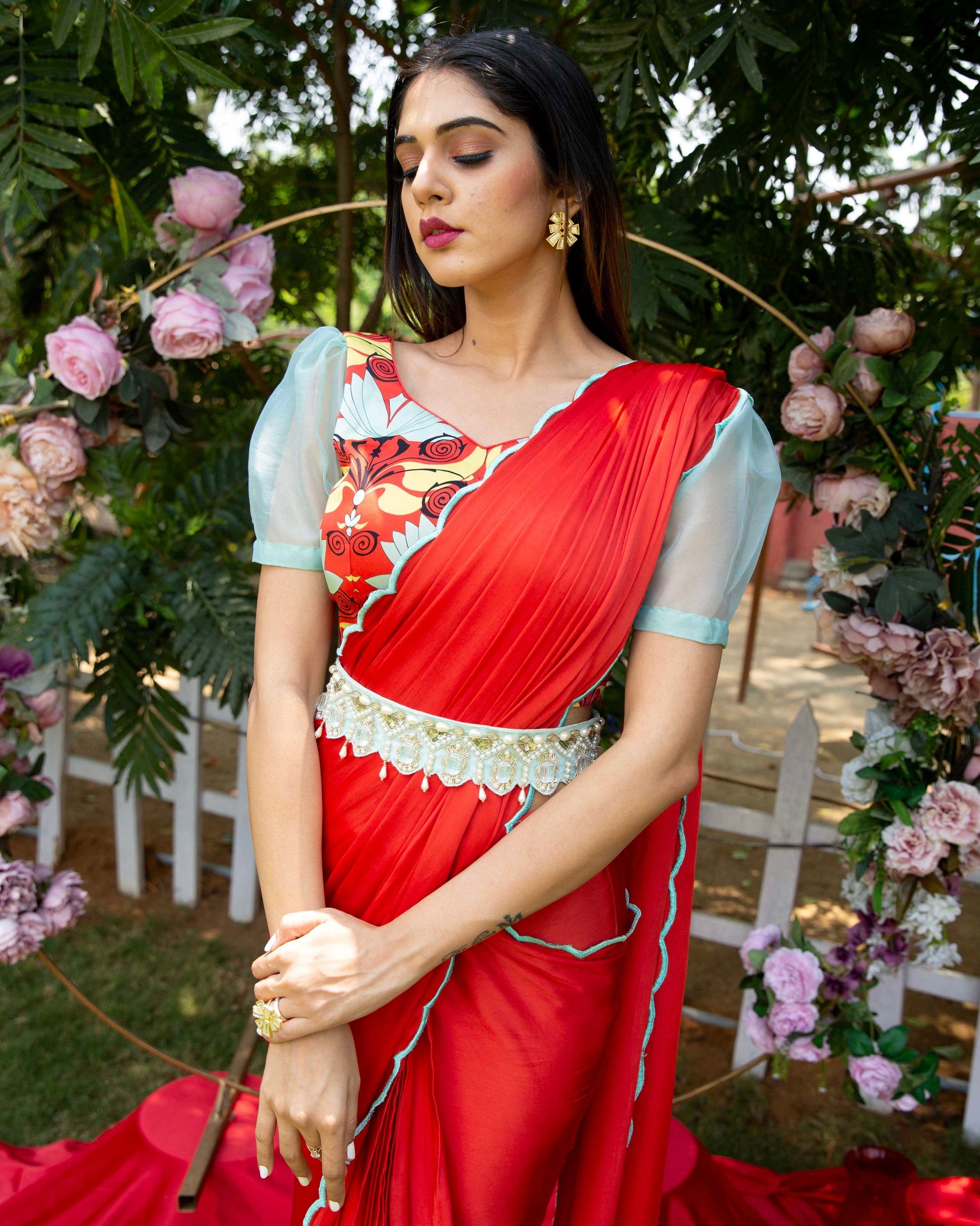 Red pre-draped saree with a printed blouse and embellished belt - Nishi Madaan Label